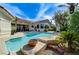 Resort-style pool with a spillover spa and mature landscaping for ultimate privacy and relaxation at 2345 Villandry Ct, Henderson, NV 89074