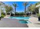 Beautiful backyard pool with a waterfall feature and a built-in bar area is perfect for entertaining at 2345 Villandry Ct, Henderson, NV 89074