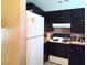 Kitchen features black cabinets and white appliances at 2349 Cardiff Ln # B, Las Vegas, NV 89108