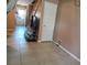 Open-concept living area with tile flooring, neutral walls, and staircase access at 2349 Cardiff Ln # B, Las Vegas, NV 89108