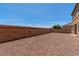 Spacious backyard features a rock surface and brick wall at 2521 Cattrack Ave, North Las Vegas, NV 89081