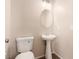 Practical half-bathroom featuring a toilet and pedestal sink with modern fixtures at 2521 Cattrack Ave, North Las Vegas, NV 89081