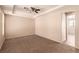 Spacious bedroom with plush carpet, ceiling fan, and access to an ensuite bathroom at 2521 Cattrack Ave, North Las Vegas, NV 89081