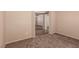 Neutral bedroom boasting soft carpeting and access to other rooms in the house at 2521 Cattrack Ave, North Las Vegas, NV 89081