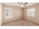 Bedroom featuring neutral walls, carpet, and natural light from two windows at 2521 Cattrack Ave, North Las Vegas, NV 89081