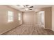 Bedroom featuring neutral walls, carpet, and natural light from two windows at 2521 Cattrack Ave, North Las Vegas, NV 89081
