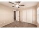 Neutral bedroom featuring a ceiling fan, carpeted floor, and closet at 2521 Cattrack Ave, North Las Vegas, NV 89081