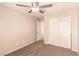 Bedroom with carpeted floors, ceiling fan, closet, and neutral paint at 2521 Cattrack Ave, North Las Vegas, NV 89081
