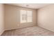 Comfortable bedroom with natural light, neutral walls, and soft carpeting at 2521 Cattrack Ave, North Las Vegas, NV 89081