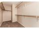 Walk-in closet features built-in shelving and hanging racks for storage at 2521 Cattrack Ave, North Las Vegas, NV 89081