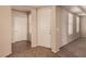Inviting entryway with neutral walls and flooring near a bright room with multiple windows at 2521 Cattrack Ave, North Las Vegas, NV 89081