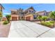 Beautiful two-story home with a three car garage and well-manicured front yard landscaping at 2521 Cattrack Ave, North Las Vegas, NV 89081
