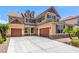 Inviting two-story home with a three car garage and classic architectural details at 2521 Cattrack Ave, North Las Vegas, NV 89081