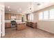Well-lit kitchen with wooden cabinets, stainless steel appliances, and a functional center island at 2521 Cattrack Ave, North Las Vegas, NV 89081