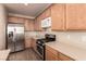 Well-lit kitchen featuring stainless steel appliances and ample cabinet space at 2521 Cattrack Ave, North Las Vegas, NV 89081