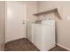 Laundry room featuring a washer, dryer, shelf, and access to the outside at 2521 Cattrack Ave, North Las Vegas, NV 89081