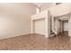 Bright living room with tile floors, offering a view of the staircase and upstairs landing at 2521 Cattrack Ave, North Las Vegas, NV 89081