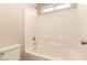 All white shower tub with tiled wall, shower head and window for natural light at 2521 Cattrack Ave, North Las Vegas, NV 89081