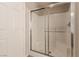 Enclosed shower features bright tile surround and a glass door at 2521 Cattrack Ave, North Las Vegas, NV 89081