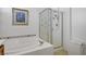 Bathroom showcasing a tiled bathtub and separate shower with glass door at 2851 Glistening Grove Ave, Henderson, NV 89052
