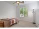 Neutral bedroom with a single bed, ceiling fan, tile flooring, and a large window for natural light at 2851 Glistening Grove Ave, Henderson, NV 89052