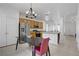 Bright kitchen features stainless steel appliances, wooden cabinets, and a stylish chandelier above the dining table at 2851 Glistening Grove Ave, Henderson, NV 89052