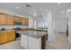 Bright kitchen with an island, stainless steel appliances, and a view into the living space at 2851 Glistening Grove Ave, Henderson, NV 89052