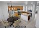 Open kitchen features wooden cabinets, stainless steel appliances, and an island with breakfast bar seating at 2851 Glistening Grove Ave, Henderson, NV 89052