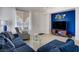 Cozy living room featuring a blue accent wall, modern furniture, and ample natural light at 2851 Glistening Grove Ave, Henderson, NV 89052