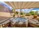 Backyard shot, featuring a covered hot tub and wooden pergola with desert landscaping at 3071 Lake Barkley Rd, Henderson, NV 89052