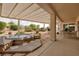 Relaxing backyard features a covered patio with hot tub, desert landscaping, and outdoor dining area at 3071 Lake Barkley Rd, Henderson, NV 89052