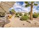 Landscaped backyard featuring desert landscaping, privacy bushes, an outdoor pergola, and comfortable seating at 3071 Lake Barkley Rd, Henderson, NV 89052