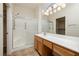 Bathroom with walk-in shower, large mirror, and bright vanity lighting at 3071 Lake Barkley Rd, Henderson, NV 89052
