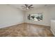 Bright, neutral bedroom with tile flooring, ceiling fan, and view of landscaped backyard at 3071 Lake Barkley Rd, Henderson, NV 89052