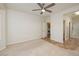 Bedroom featuring neutral carpet, ceiling fan, and en suite bathroom access at 3071 Lake Barkley Rd, Henderson, NV 89052