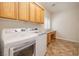 Bright laundry room with a front-loading washer/dryer, storage cabinets, and a built-in desk area at 3071 Lake Barkley Rd, Henderson, NV 89052