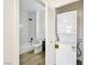 Bright bathroom features a shower-over-tub, updated fixtures, and a convenient stacked washer/dryer at 3318 N Decatur Blvd # 1107, Las Vegas, NV 89130