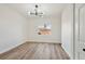 Well-lit bedroom with wood-look flooring features a modern light fixture and window at 3318 N Decatur Blvd # 1107, Las Vegas, NV 89130