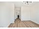 Bright bedroom featuring wood-look floors and modern lighting near an ensuite bathroom at 3318 N Decatur Blvd # 1107, Las Vegas, NV 89130