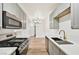 Stylish kitchen with grey cabinets, stainless steel appliances, and a view into the dining area at 3318 N Decatur Blvd # 1107, Las Vegas, NV 89130