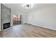 Bright living room featuring wood-look floors, a modern fireplace, and sliding glass doors to a balcony at 3318 N Decatur Blvd # 1107, Las Vegas, NV 89130