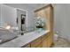 Modern bathroom featuring a glass bowl sink, light wood cabinets, and artistic decorations at 360 E Desert Inn Rd # 1803, Las Vegas, NV 89109