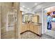 Bathroom features a dual sink vanity, a glass-enclosed shower, and a walk-in closet at 360 E Desert Inn Rd # 1803, Las Vegas, NV 89109