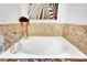 Bright bathroom features a soaking tub with elegant tile surround and marble countertop at 360 E Desert Inn Rd # 1803, Las Vegas, NV 89109