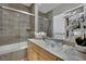 Stylish bathroom features a glass bowl sink, light wood cabinets, and a glass enclosed bathtub at 360 E Desert Inn Rd # 1803, Las Vegas, NV 89109