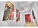 Hallway featuring hardwood floors, unique artwork, and multiple doorways leading to various rooms at 360 E Desert Inn Rd # 1803, Las Vegas, NV 89109
