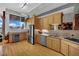 Modern kitchen featuring stainless steel appliances, wooden cabinetry, granite countertops, and stunning city views at 360 E Desert Inn Rd # 1803, Las Vegas, NV 89109
