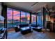 Stunning living room with a city view, floor-to-ceiling windows and modern black leather sectional at 360 E Desert Inn Rd # 1803, Las Vegas, NV 89109