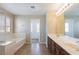 Bathroom with large tub, tiled floor, and double vanity sink at 3615 Dutchmans Vine Ct, North Las Vegas, NV 89081