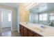 Bathroom features a double sink vanity, bathtub, shower, and white countertops at 3615 Dutchmans Vine Ct, North Las Vegas, NV 89081